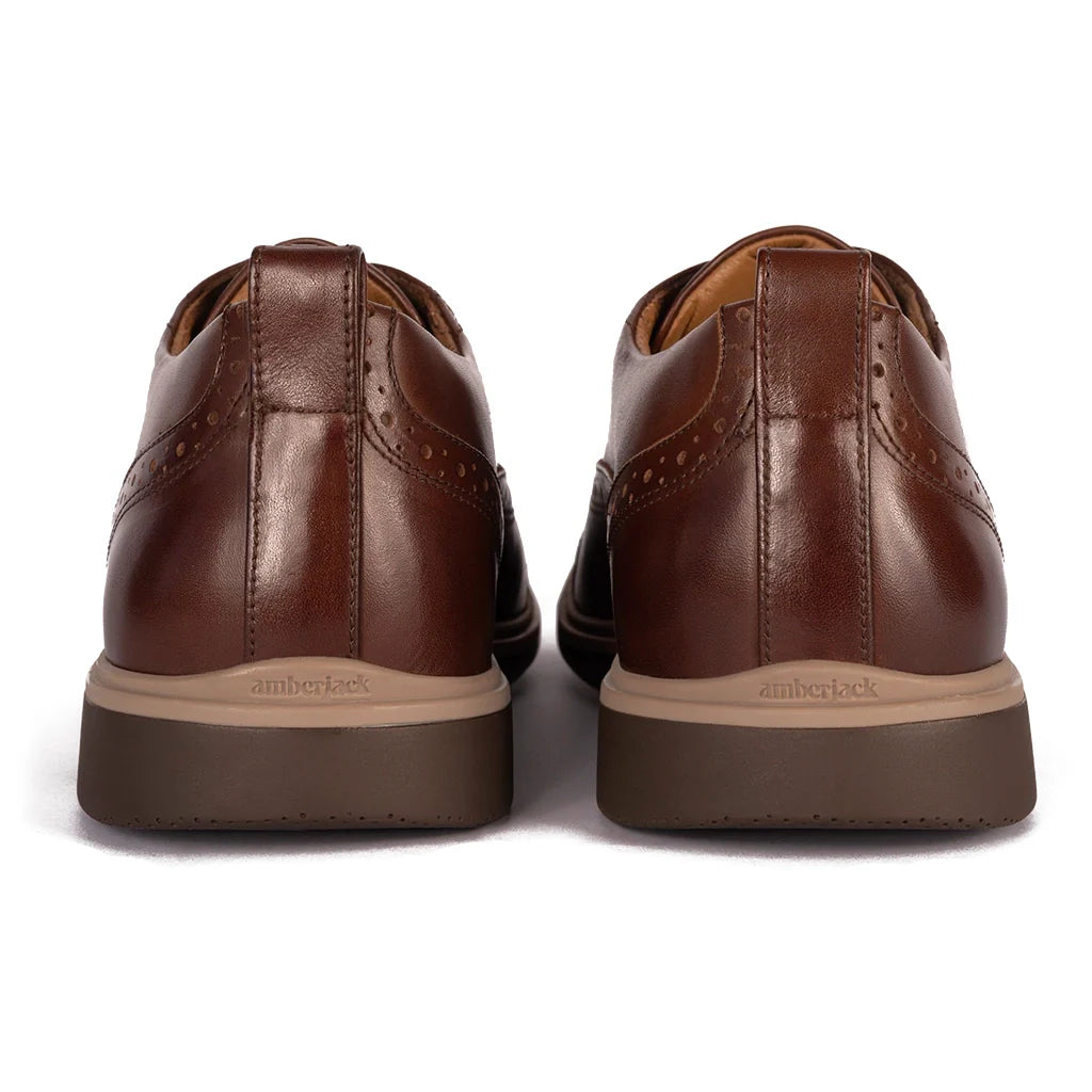 Brown leather shoes with 'Timberland' branding on a white background
