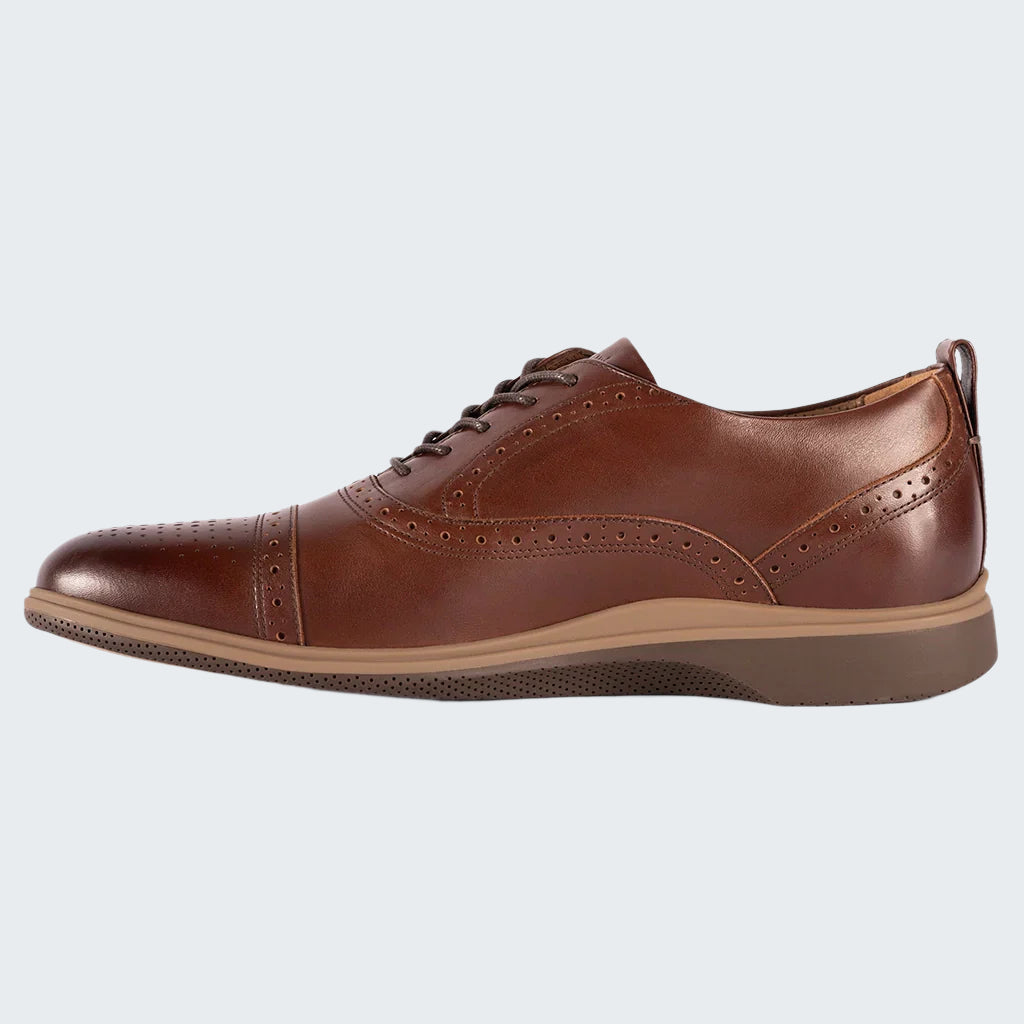 Brown leather dress shoe on a white background