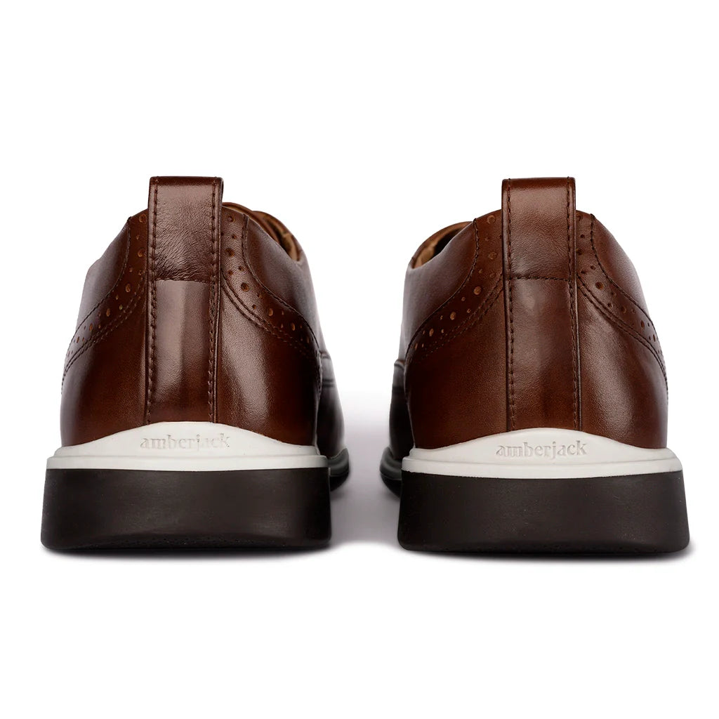 Brown leather shoes with white soles on a white background