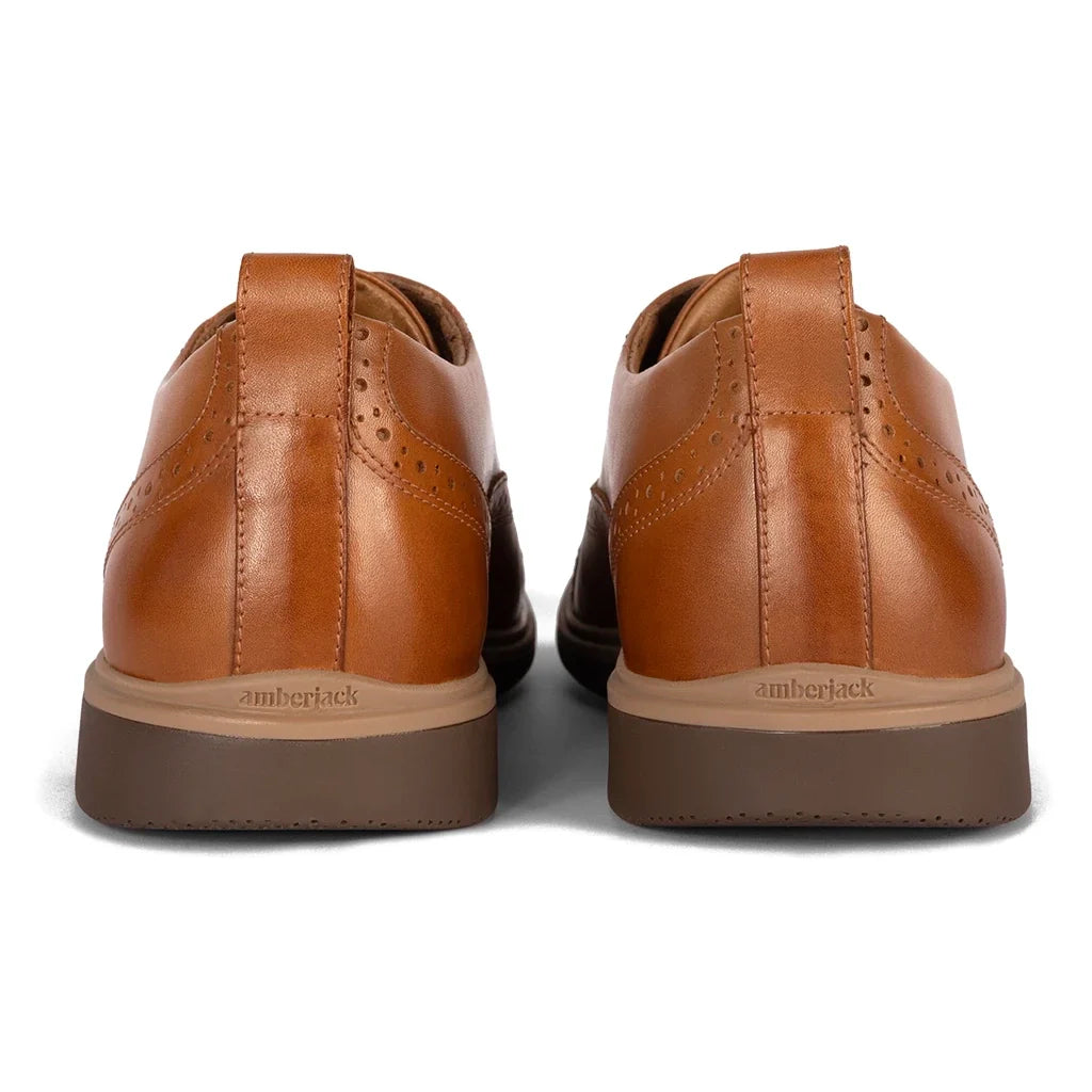 Pair of brown leather shoes with 'amberjack' branding on a white background
