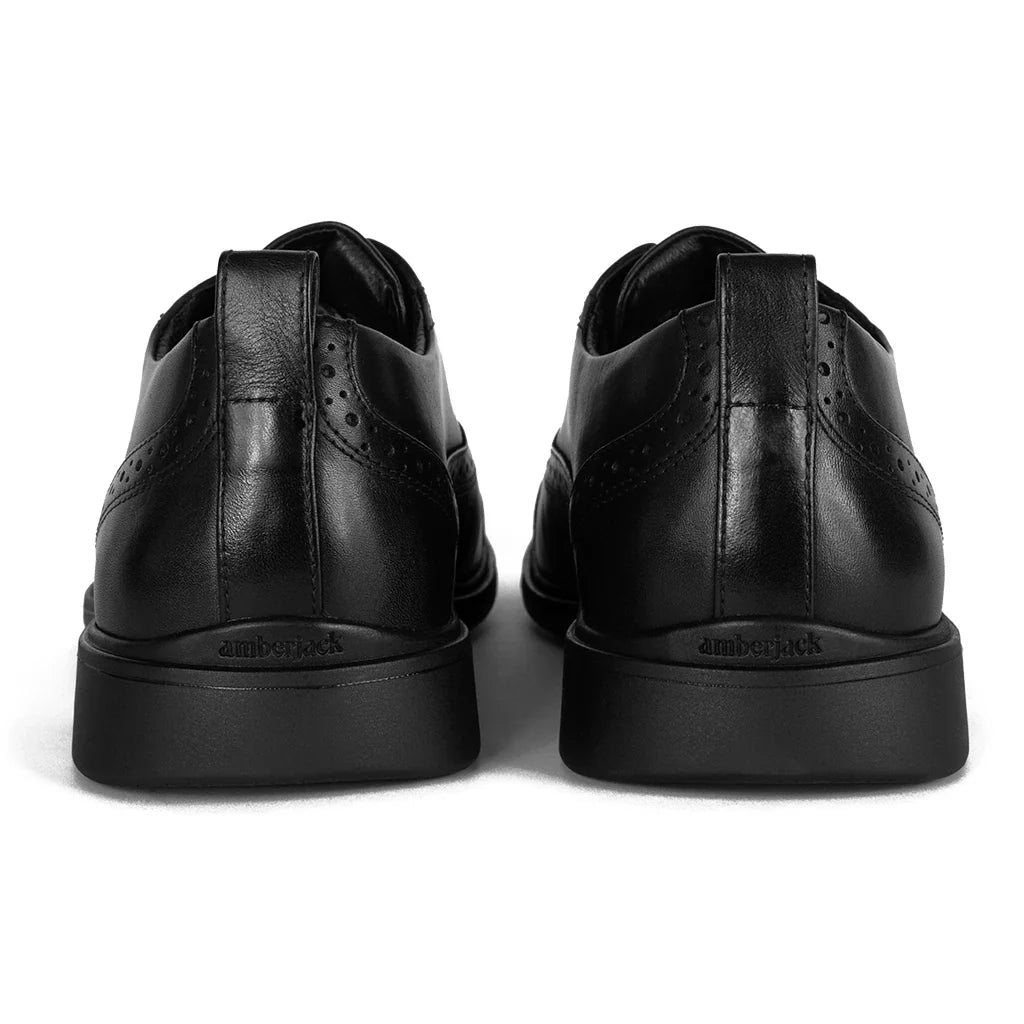 Black leather shoes with 'amberjack' branding on a white background