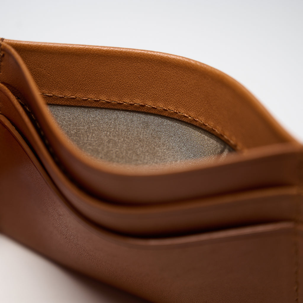 Close-up of a brown leather product with a textured interior