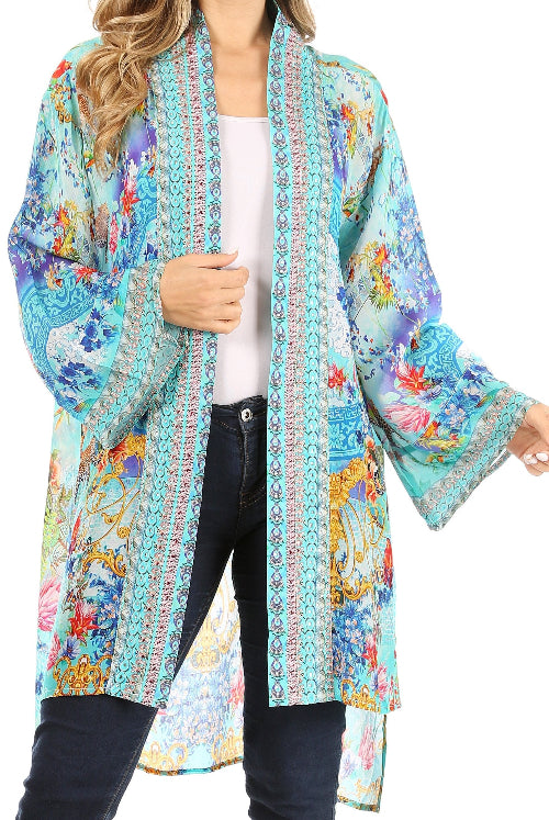 Woman wearing a colorful kimono-style jacket with a white shirt and black pants on a white background