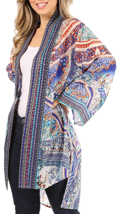Woman wearing a colorful patterned kimono-style jacket on a white background