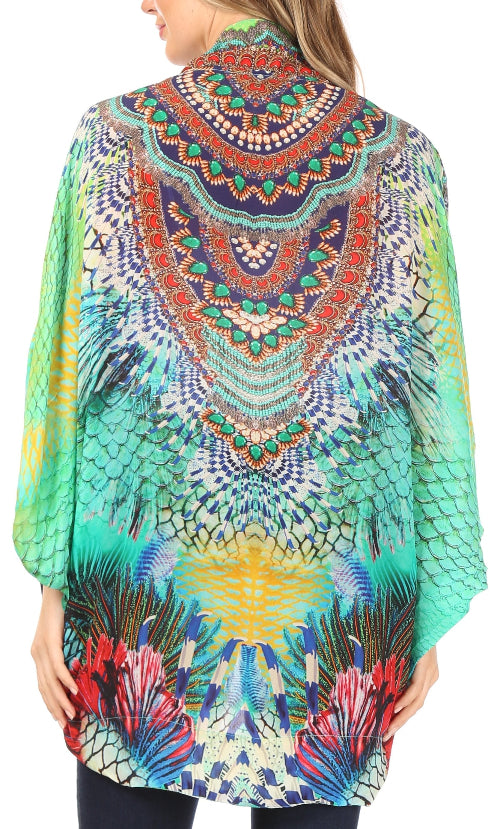 Colorful patterned poncho worn by a person on a white background