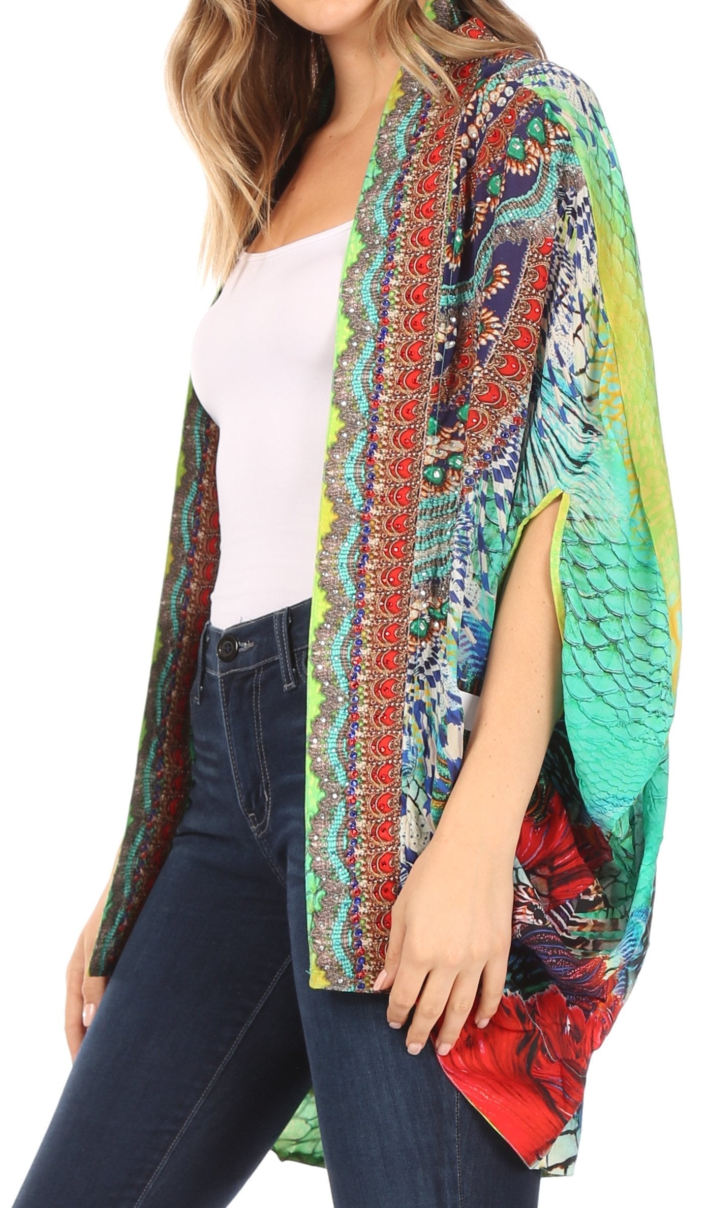 Woman wearing a colorful patterned kimono over a white top and jeans on a white background