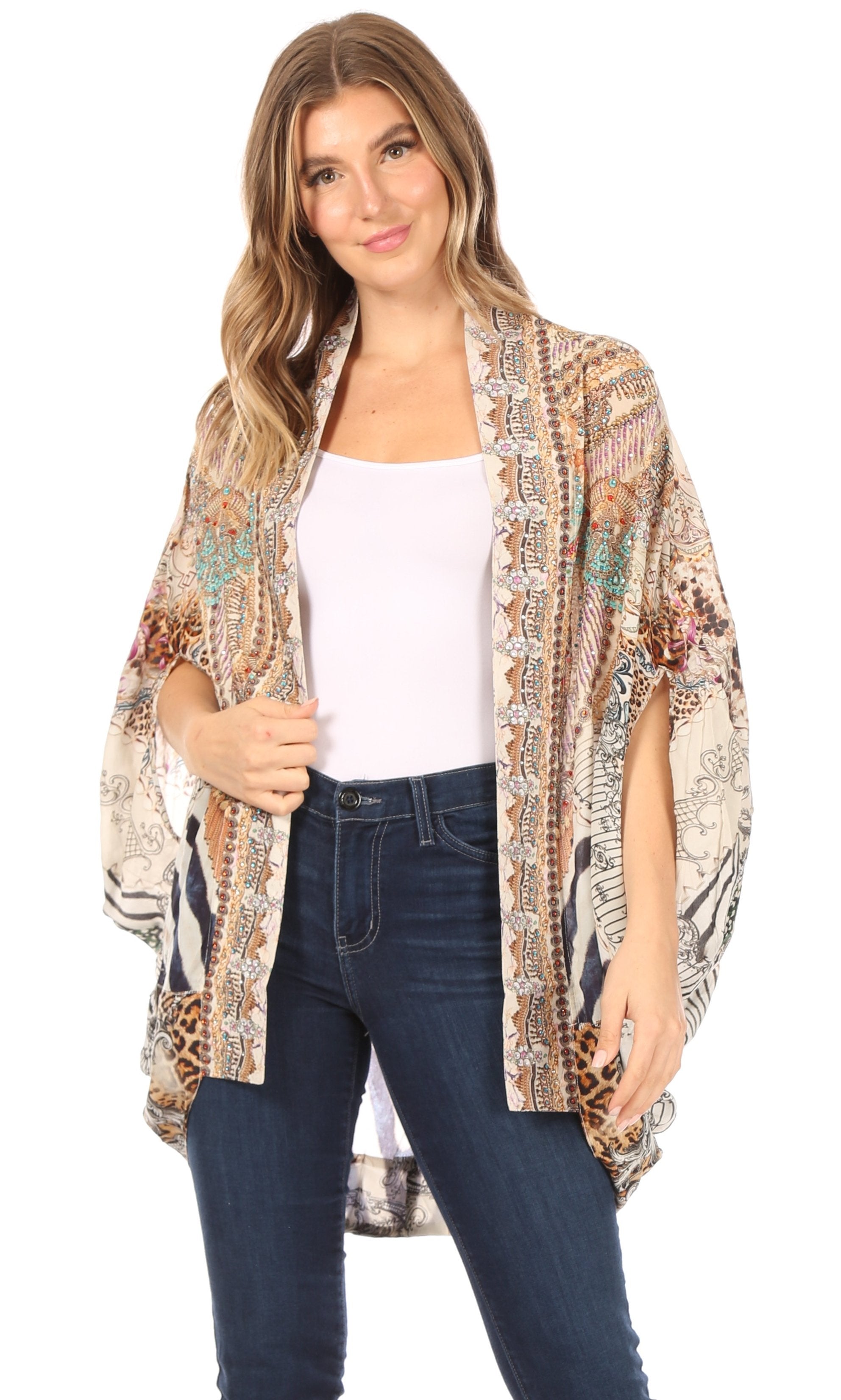 Woman wearing a patterned kimono over a white top and jeans on a white background