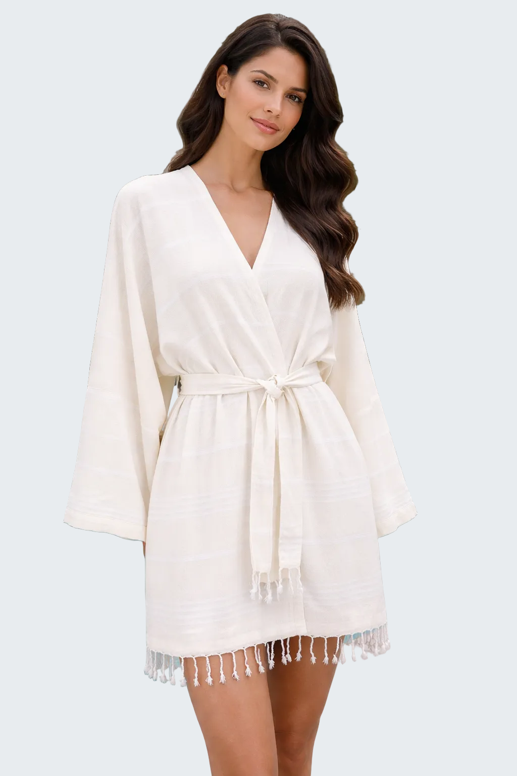 Woman wearing a white robe by a poolside