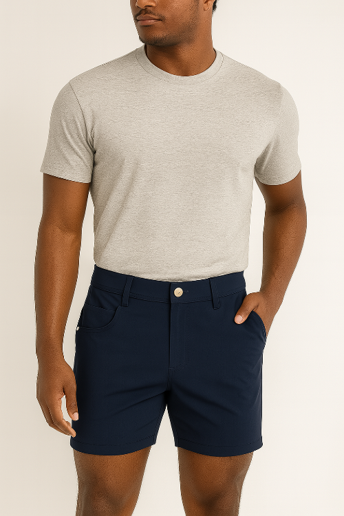 Man wearing a gray t-shirt and navy shorts on a beige background