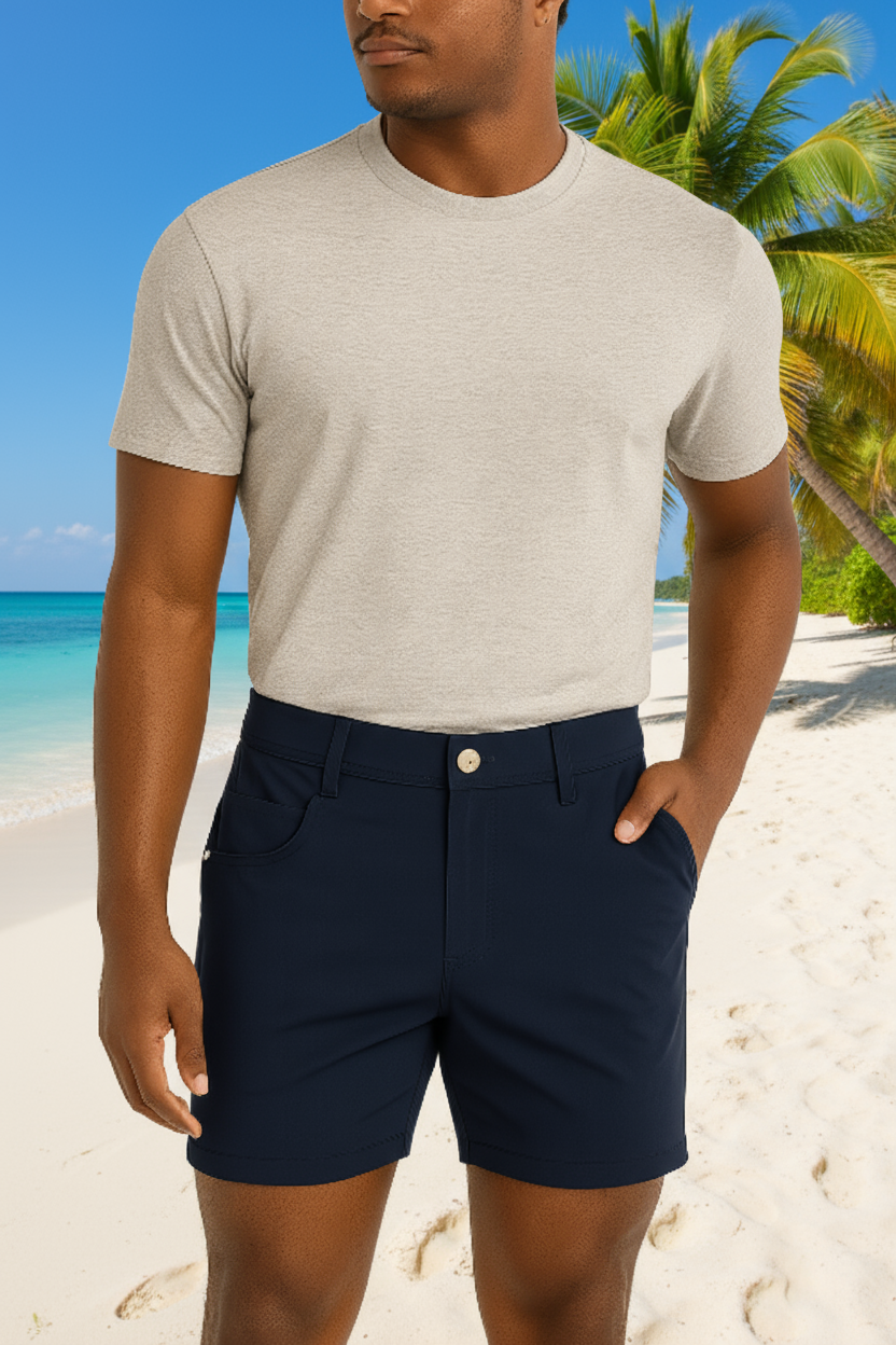 Man wearing a gray t-shirt and navy shorts on a beige background