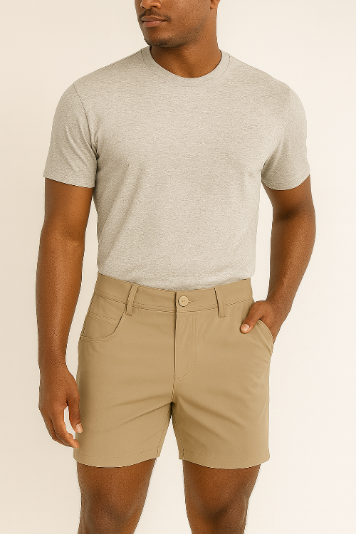Man wearing a gray t-shirt and beige shorts on a beige background