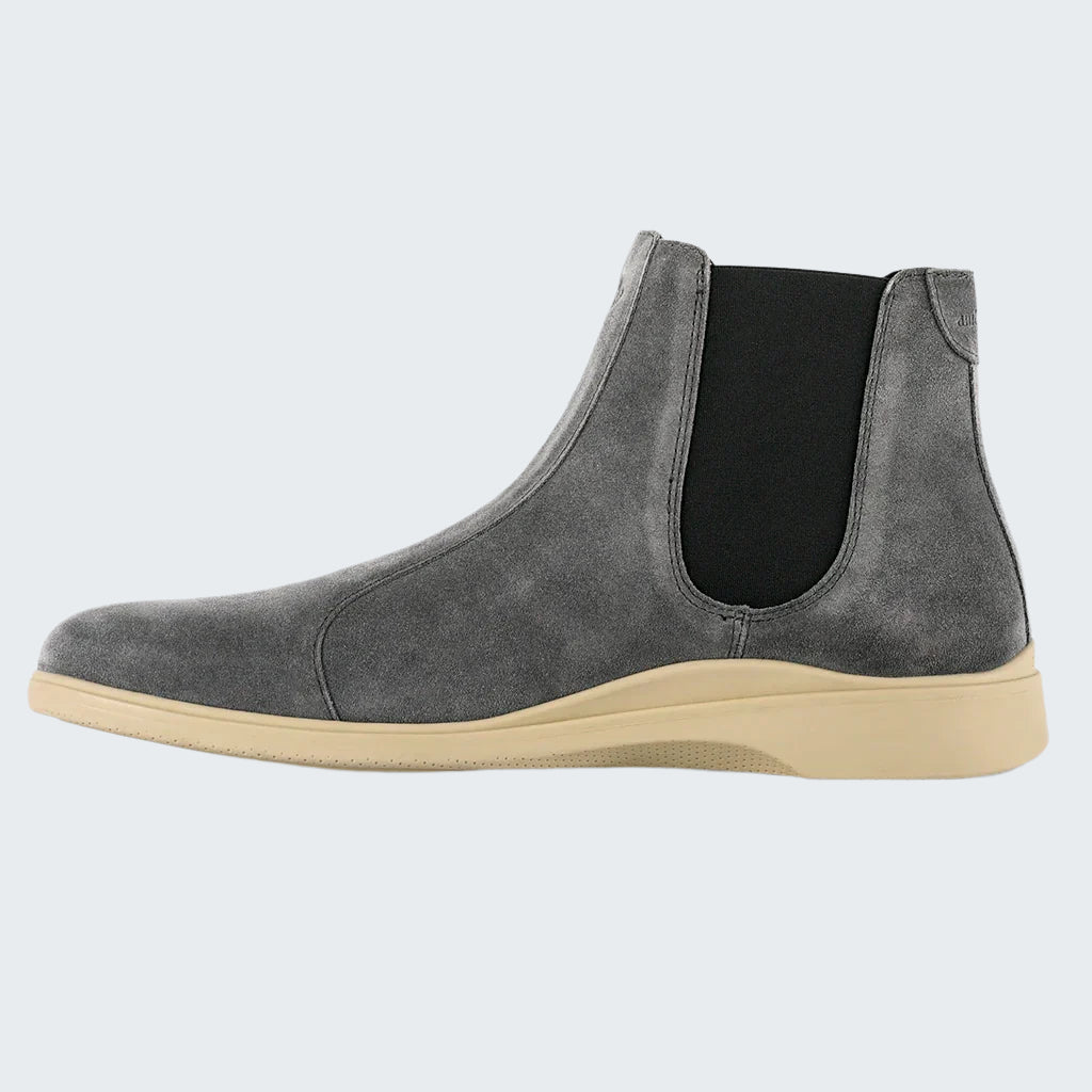 Gray suede Chelsea boot with beige sole on a white background