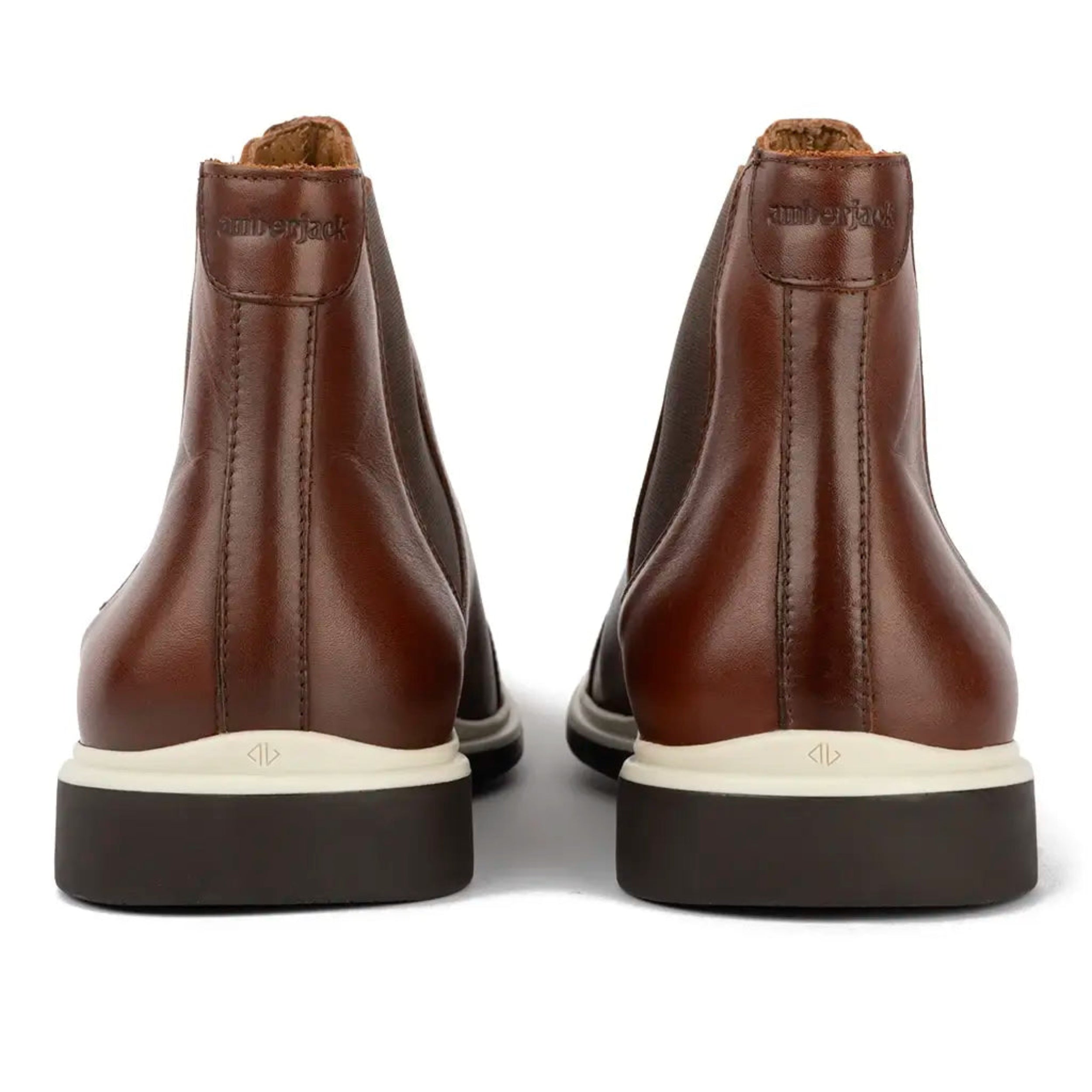 Brown leather boots with white soles on a white background