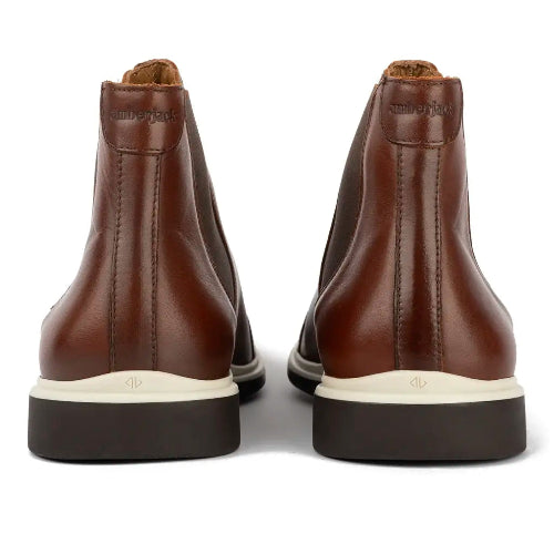 Brown leather boots with white soles on a white background