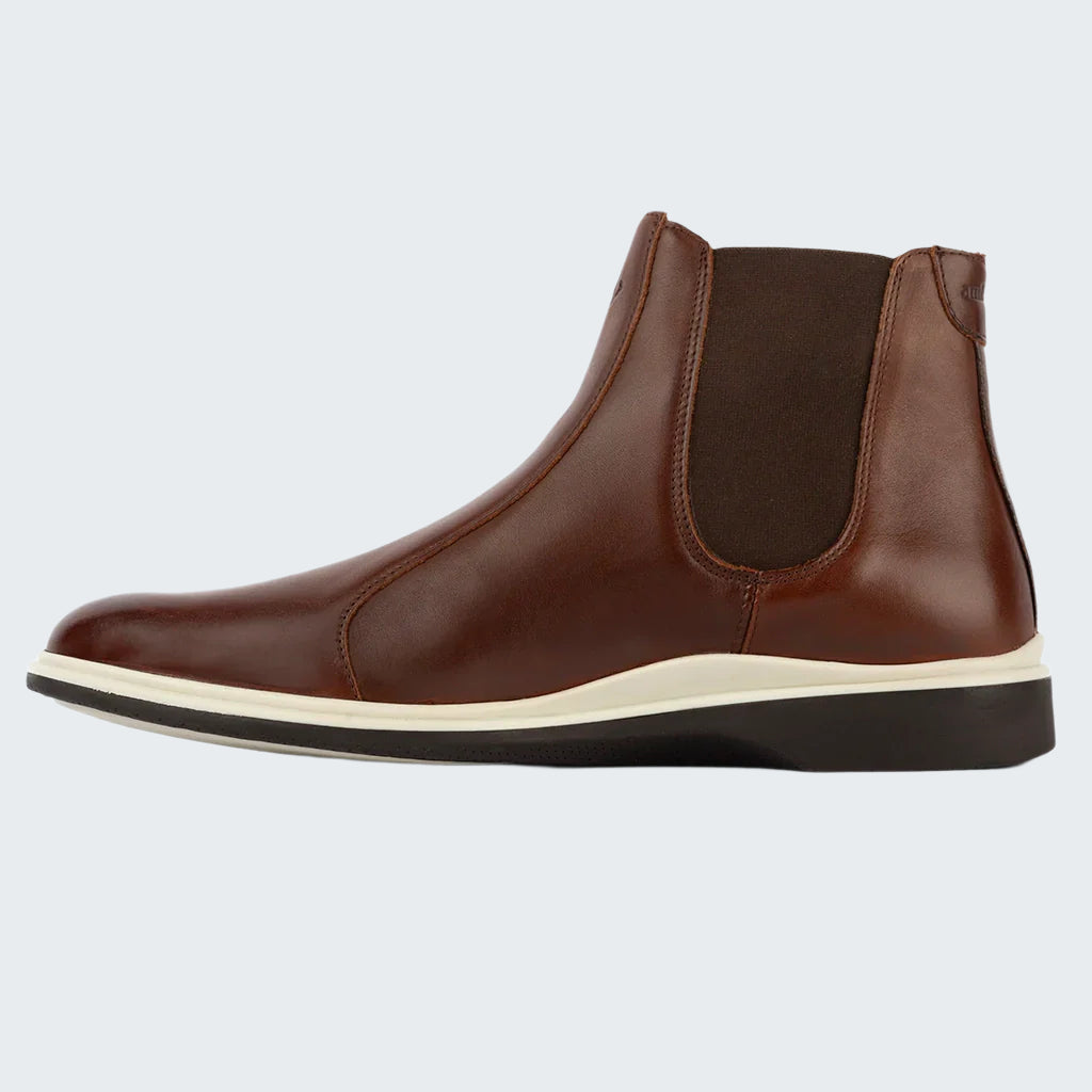 Brown leather Chelsea boot on a white background