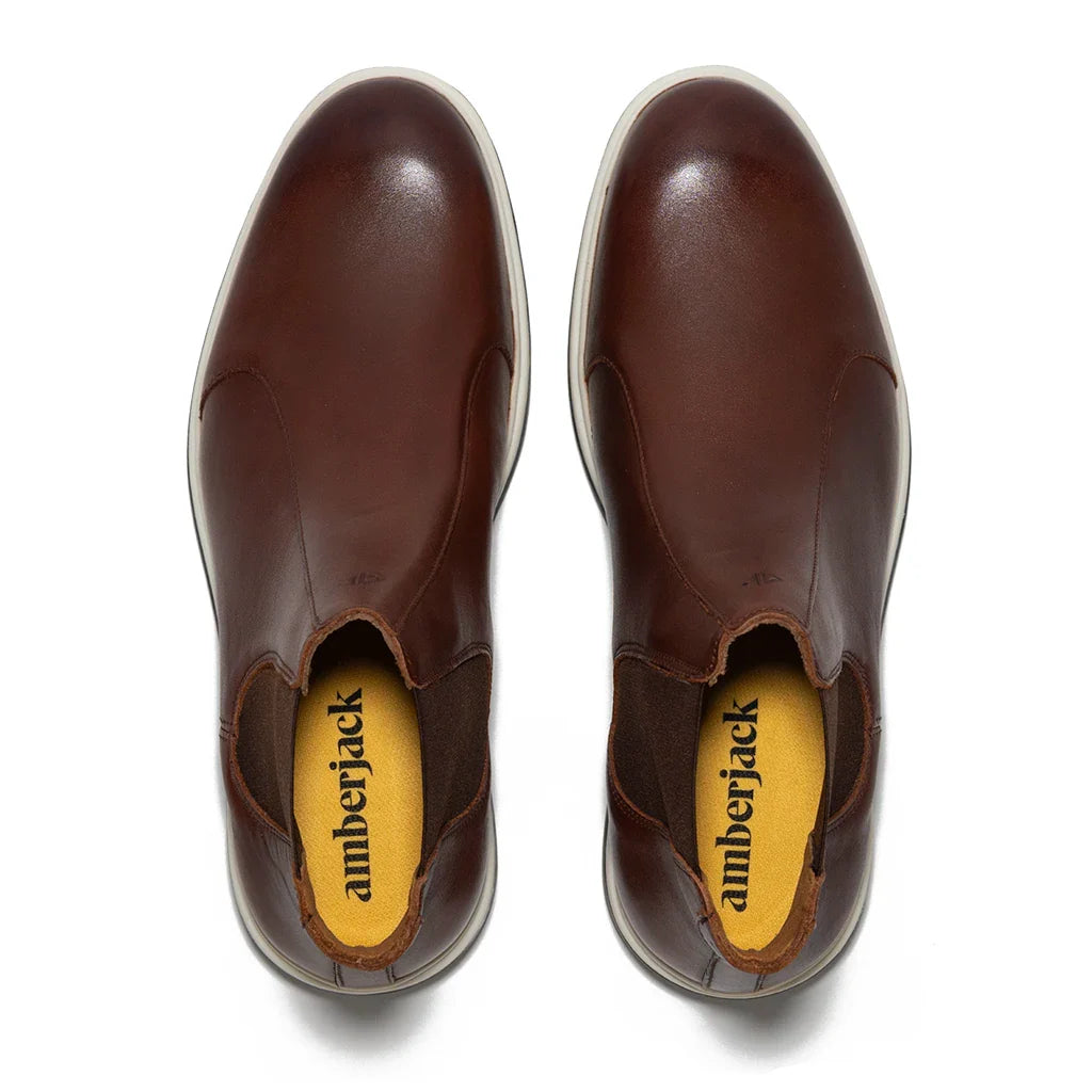 Pair of brown shoes with 'amberjack' branding on a white background