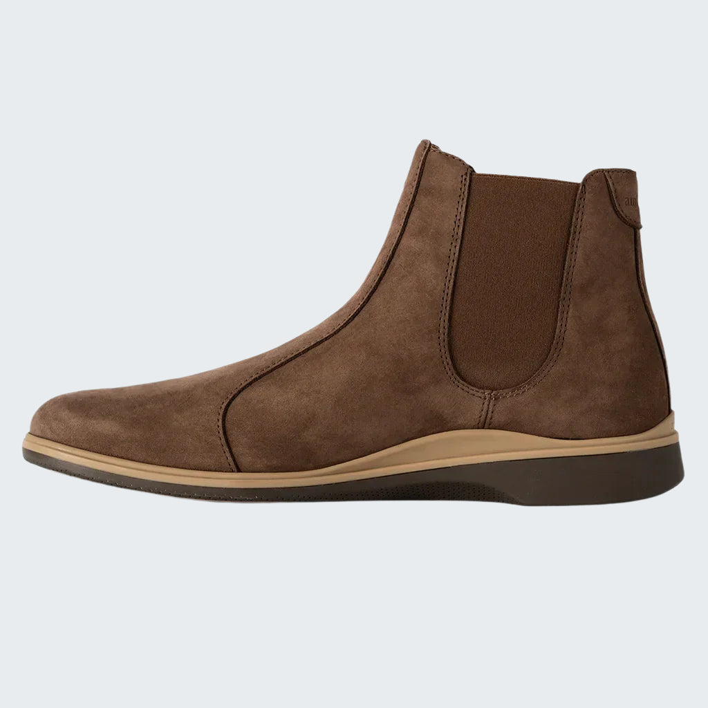 Brown leather Chelsea boot on a white background