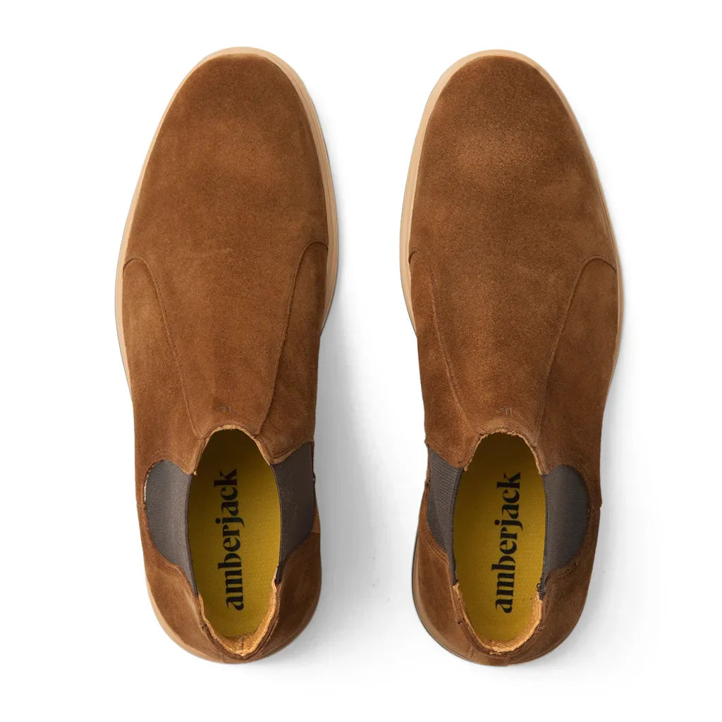 Pair of brown suede shoes with 'amberjack' branding on a white background