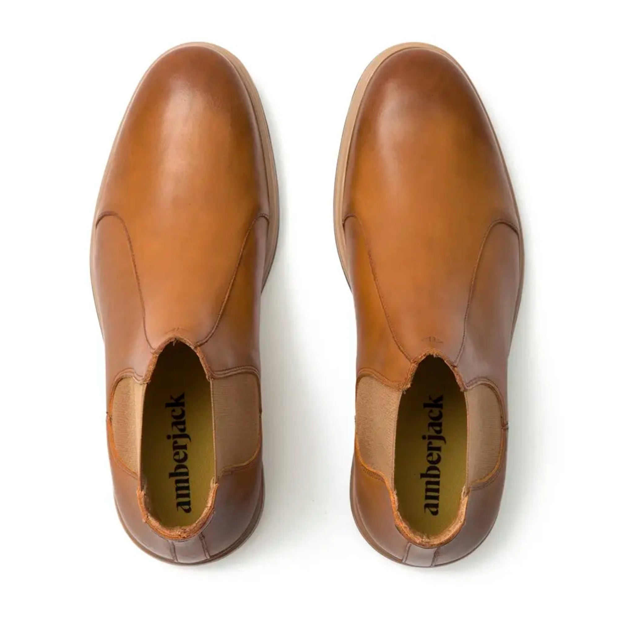 Pair of brown leather shoes with 'amberjack' branding on a white background