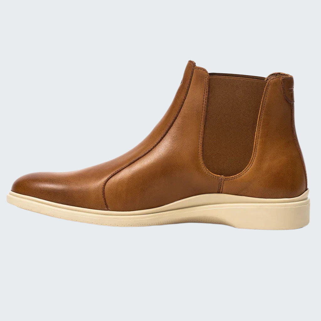 Brown leather Chelsea boot on a white background