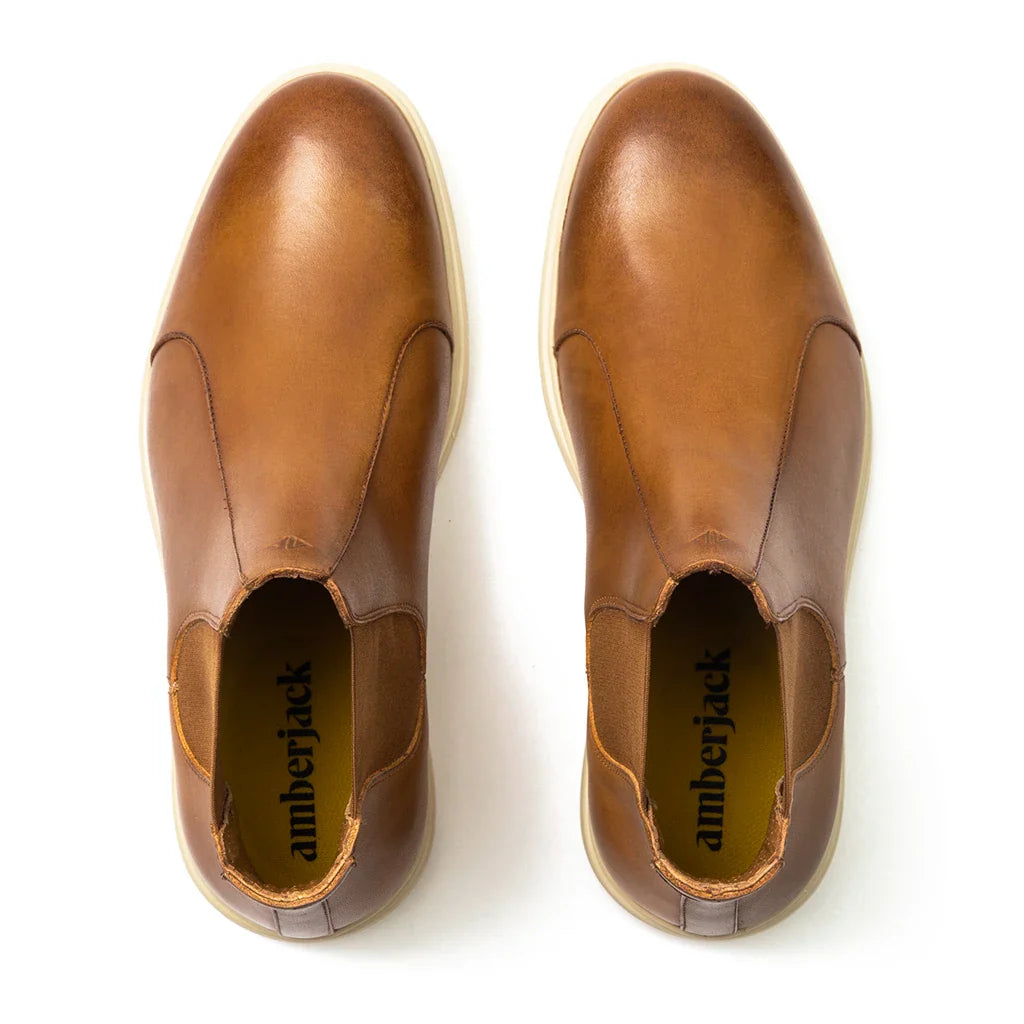 Pair of brown leather shoes with 'amberjack' branding on a white background