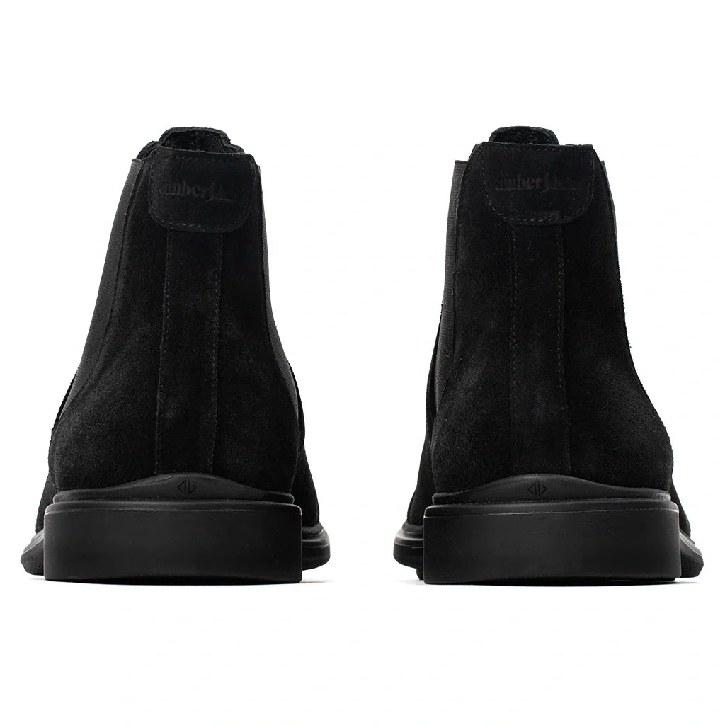 Black suede shoes with 'Camper' branding on a white background