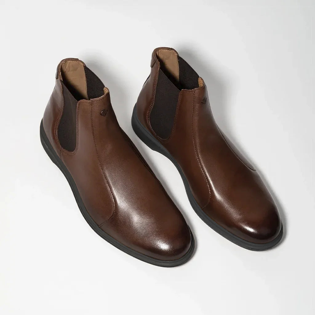 Pair of brown leather boots on a white background