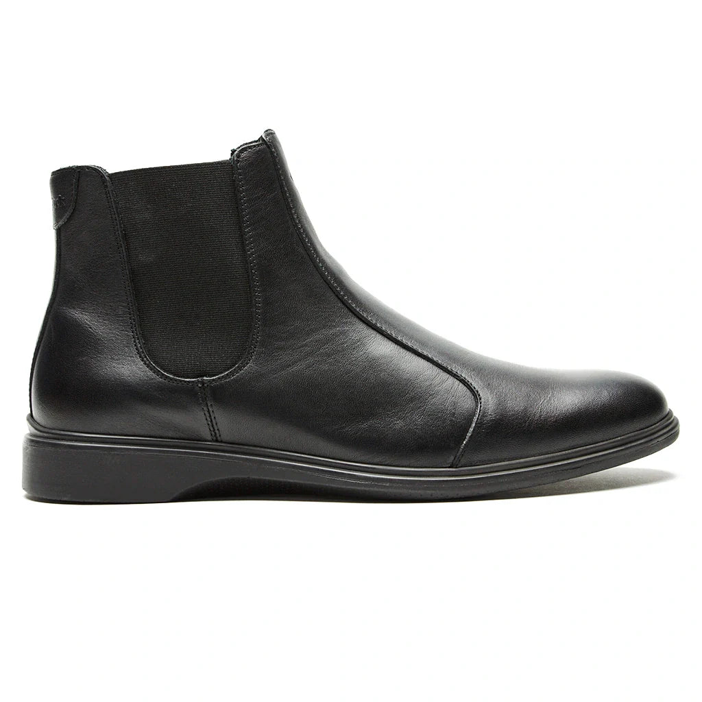 Black leather Chelsea boot on a white background