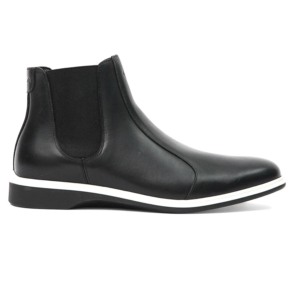 Black ankle boot with white sole on a white background