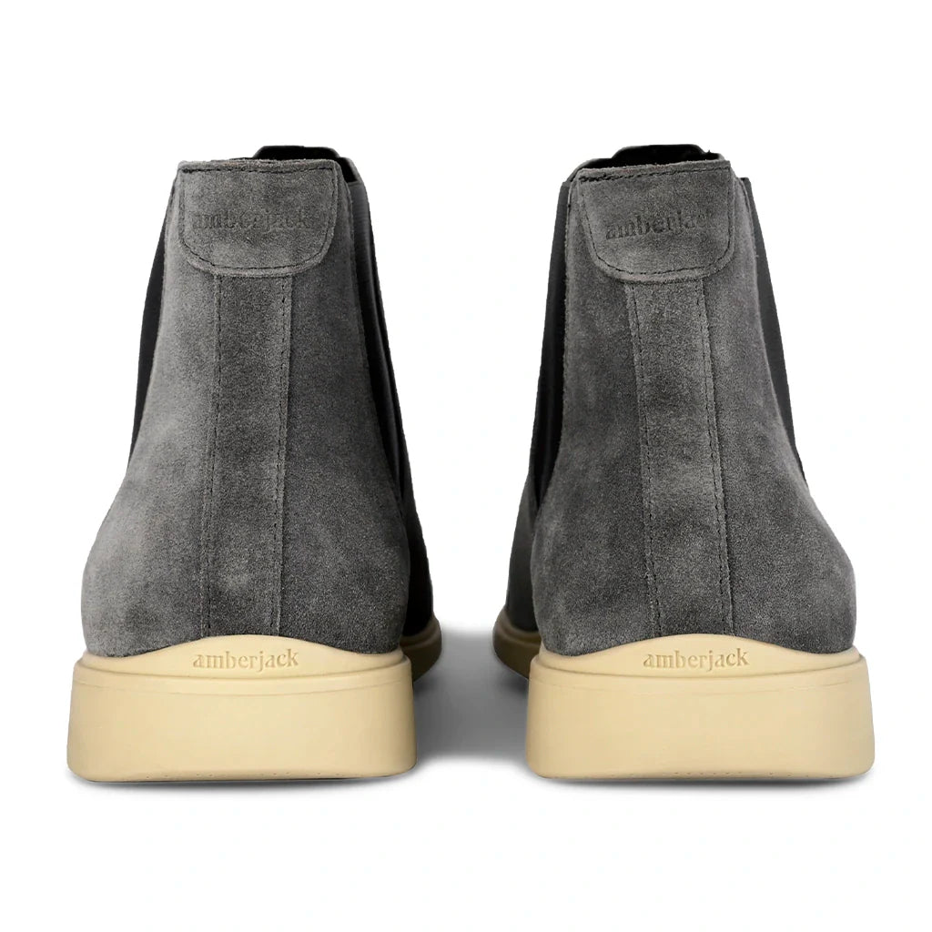 Gray high-top sneakers with beige soles on a white background