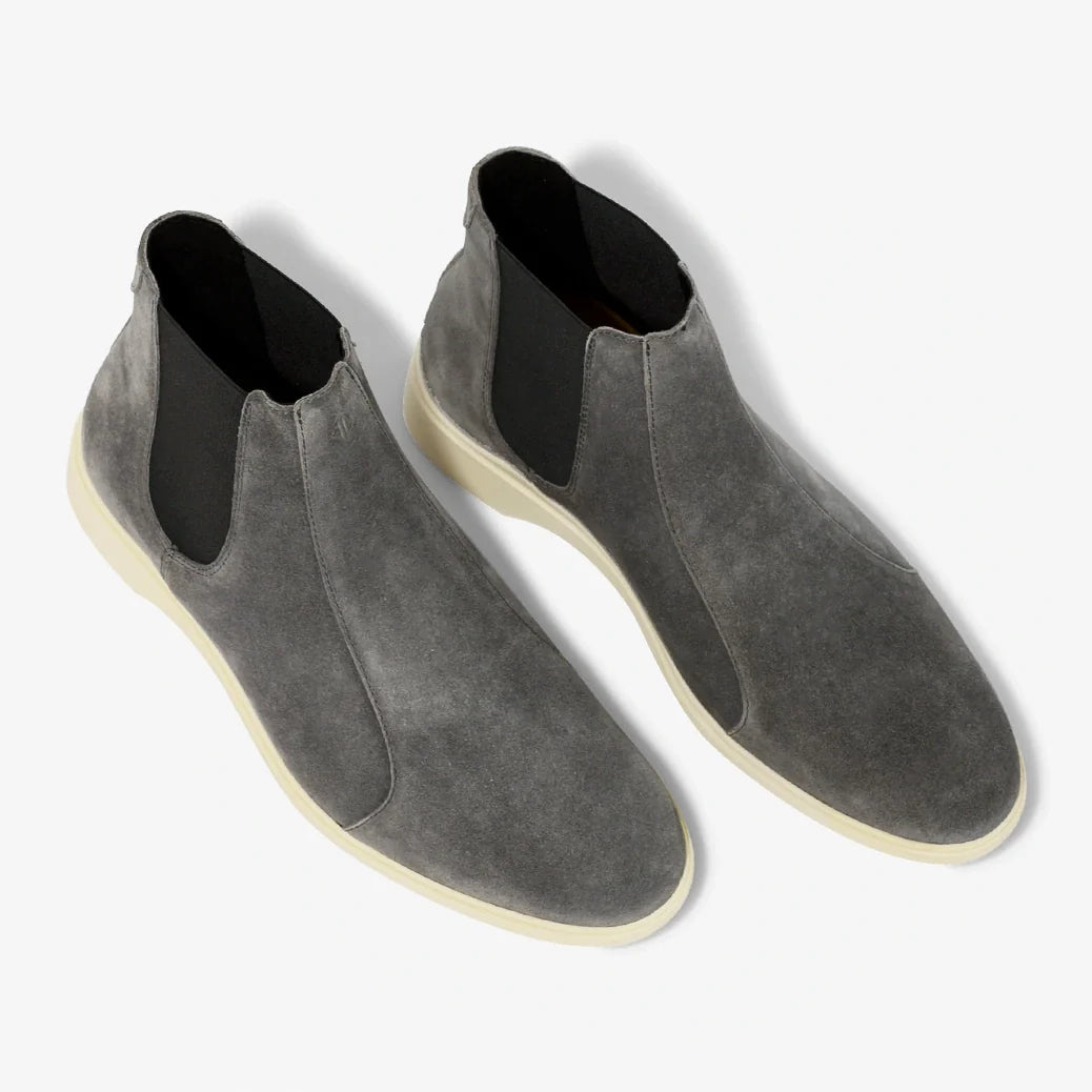 Pair of gray suede Chelsea boots on a white background