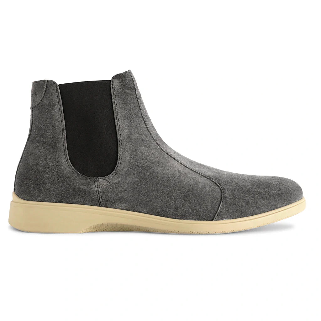 Gray suede Chelsea boot with beige sole on a white background