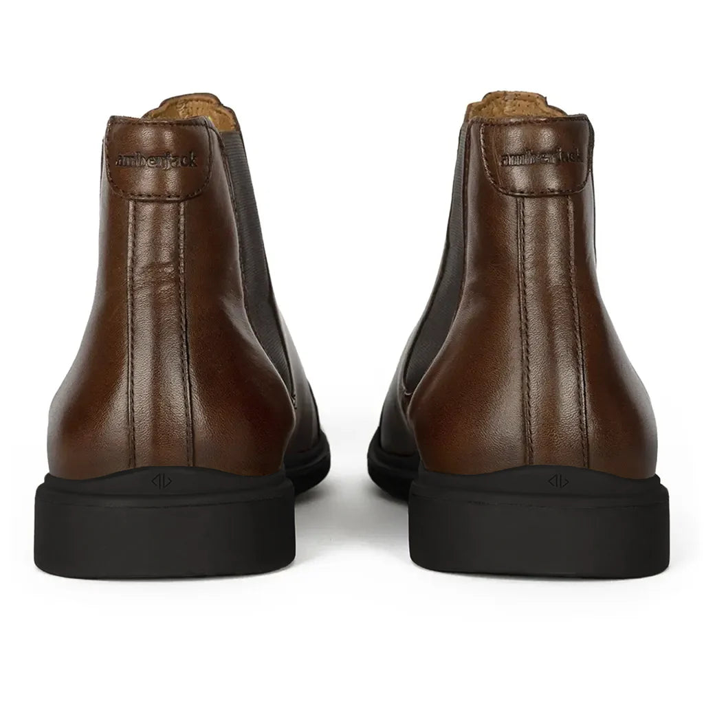 Pair of brown leather boots on a white background