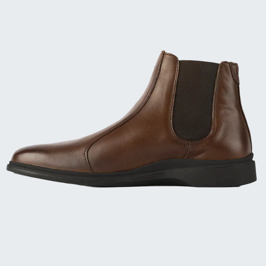 Brown leather Chelsea boot on a white background