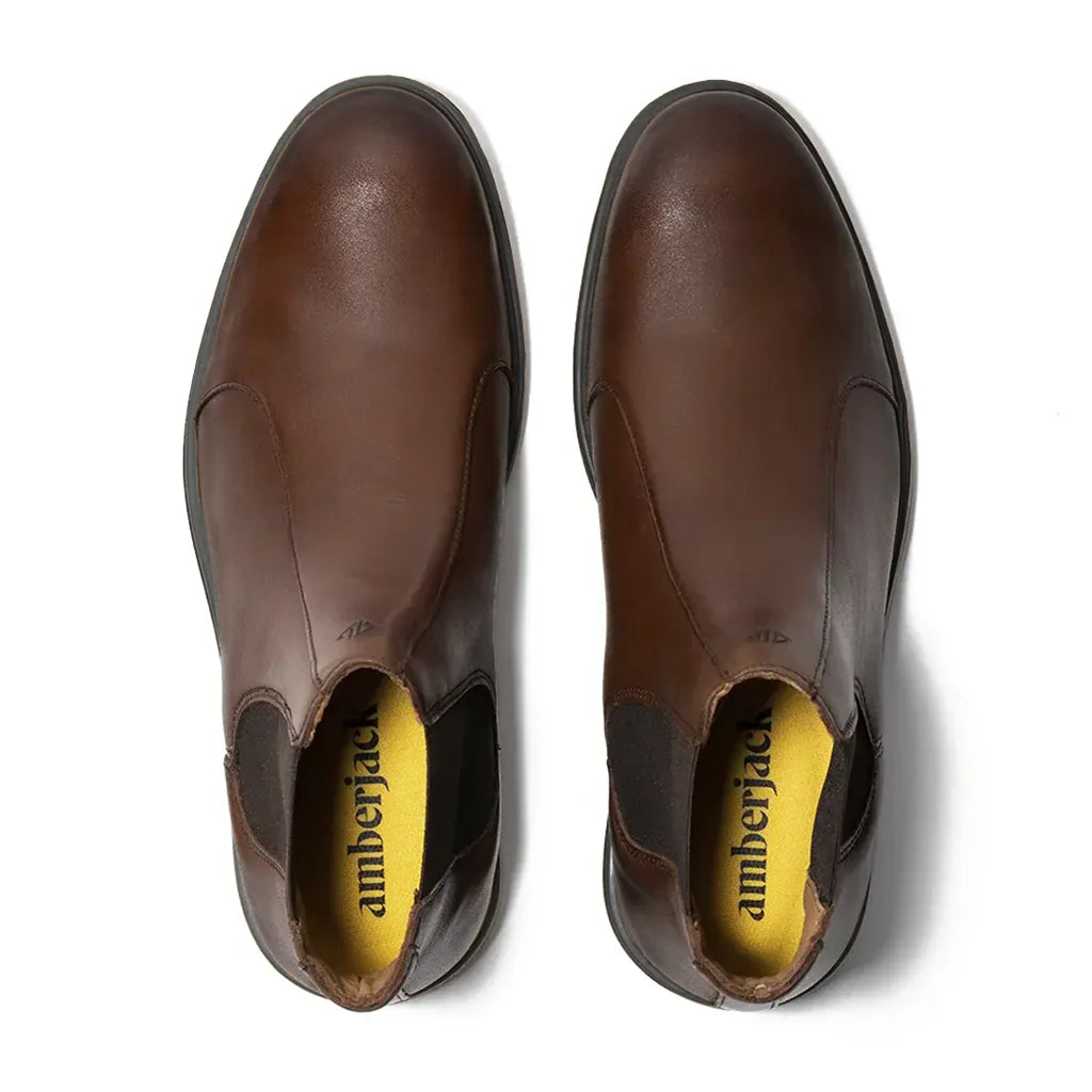 Pair of brown leather shoes with 'amberjack' branding on a white background