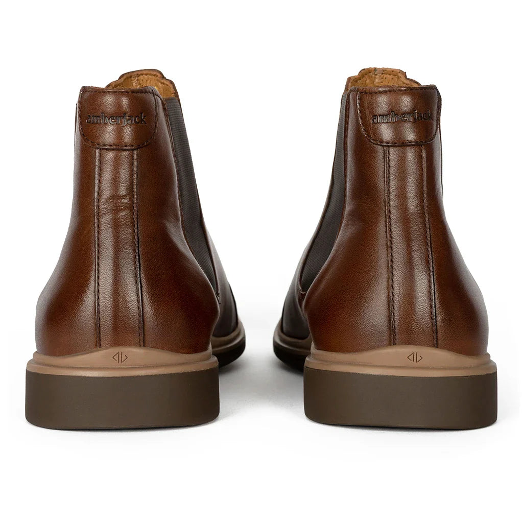 Pair of brown leather boots on a white background