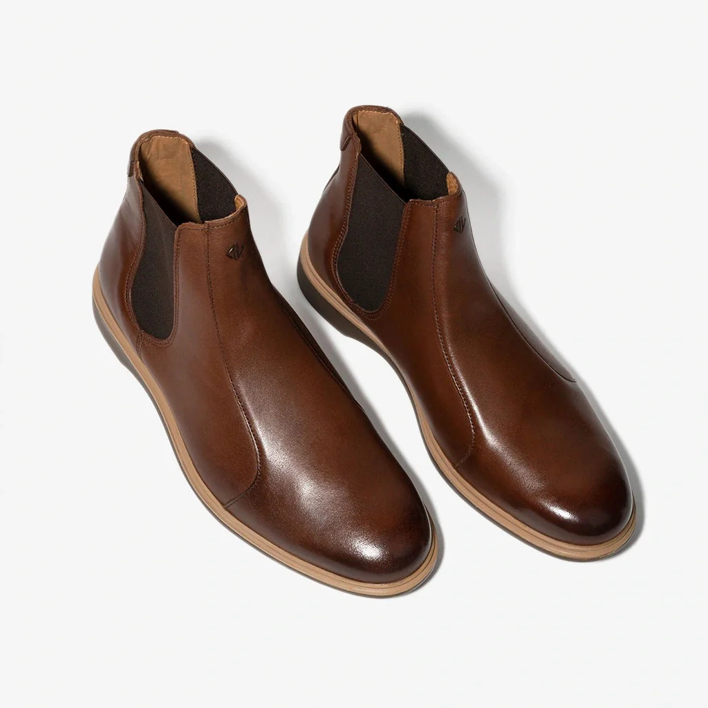 Pair of brown leather boots on a white background