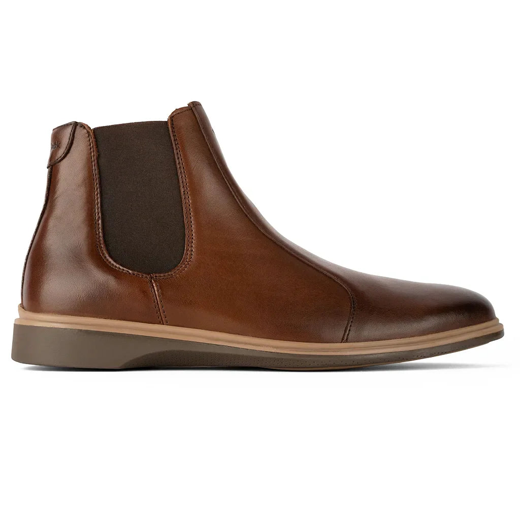 Brown leather Chelsea boot on a white background