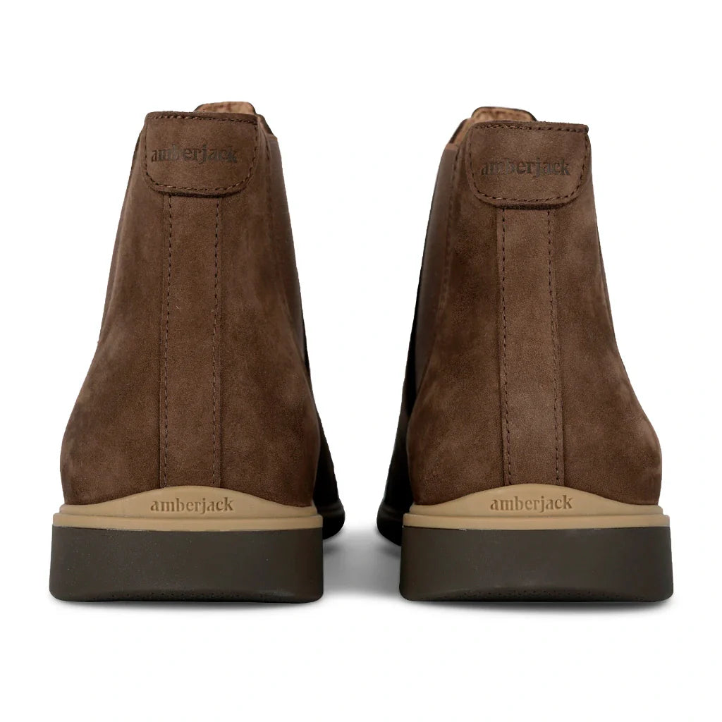 Pair of brown leather equestrian boots with 'amberjack' branding on a white background