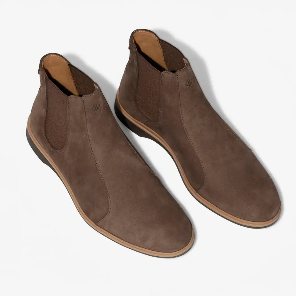 Pair of brown suede ankle boots on a white background