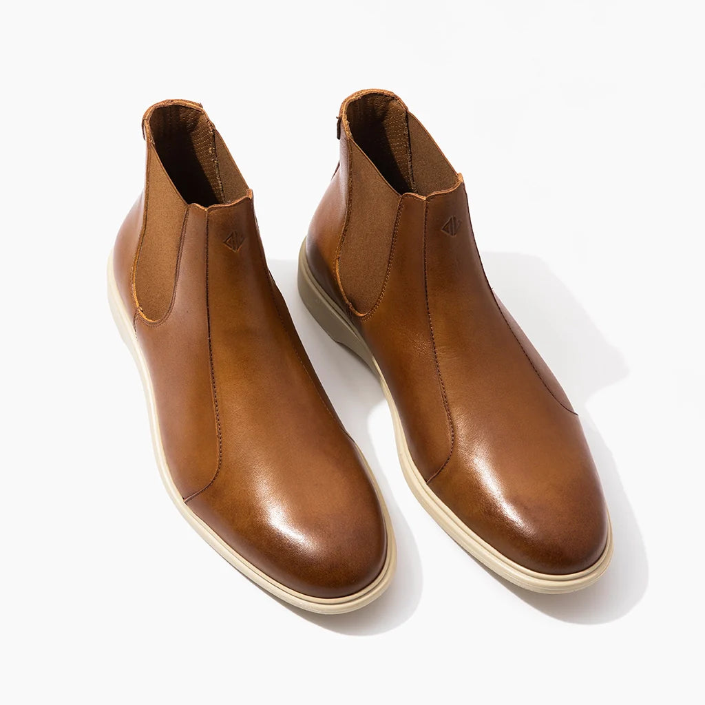 Pair of brown leather boots on a white background