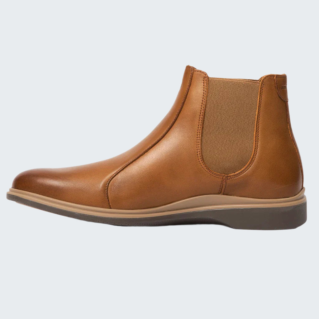 Brown leather Chelsea boot on a white background
