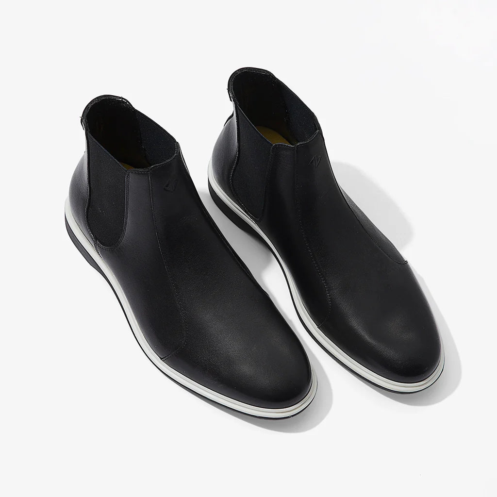 Pair of black Chelsea boots on a white background