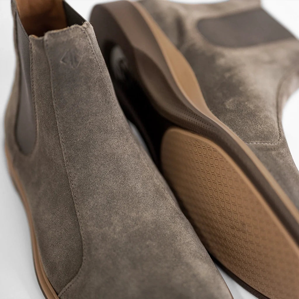 Brown suede shoe with a white background