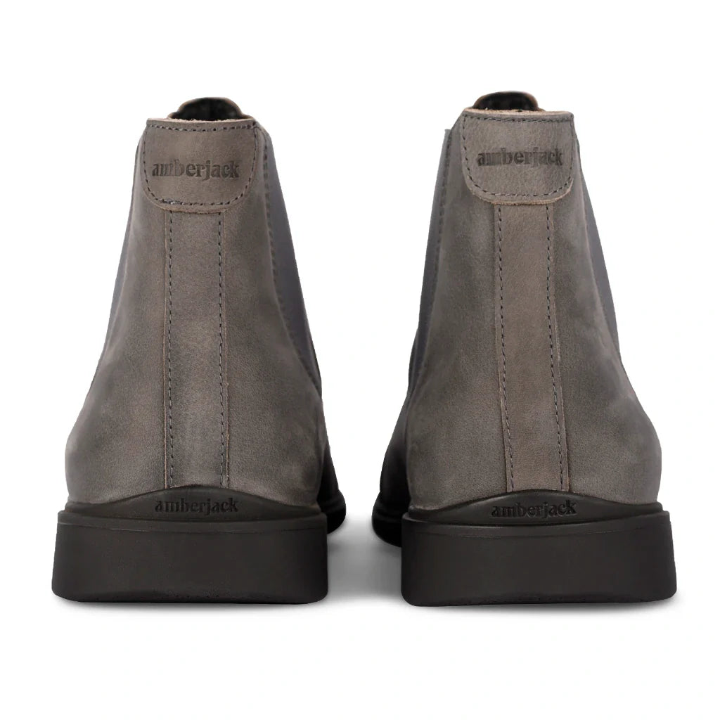 Pair of gray work boots with 'Timberland' branding on a white background