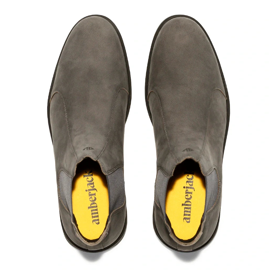 Pair of gray suede ankle boots with yellow interior on a white background