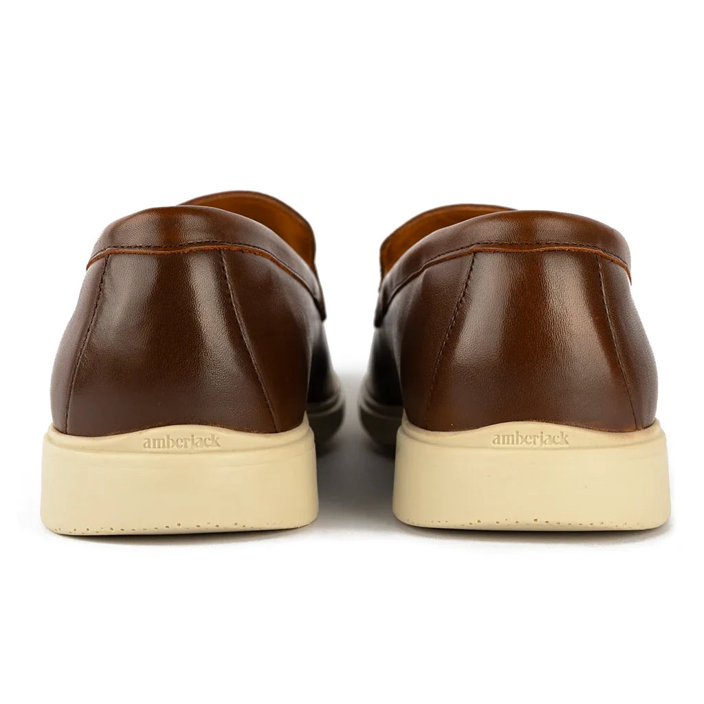 Brown leather shoes with beige soles on a white background