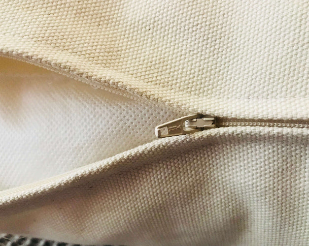 Close-up of a beige fabric with a zipper