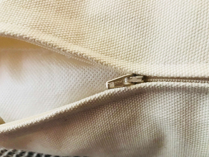 Close-up of a beige fabric with a zipper