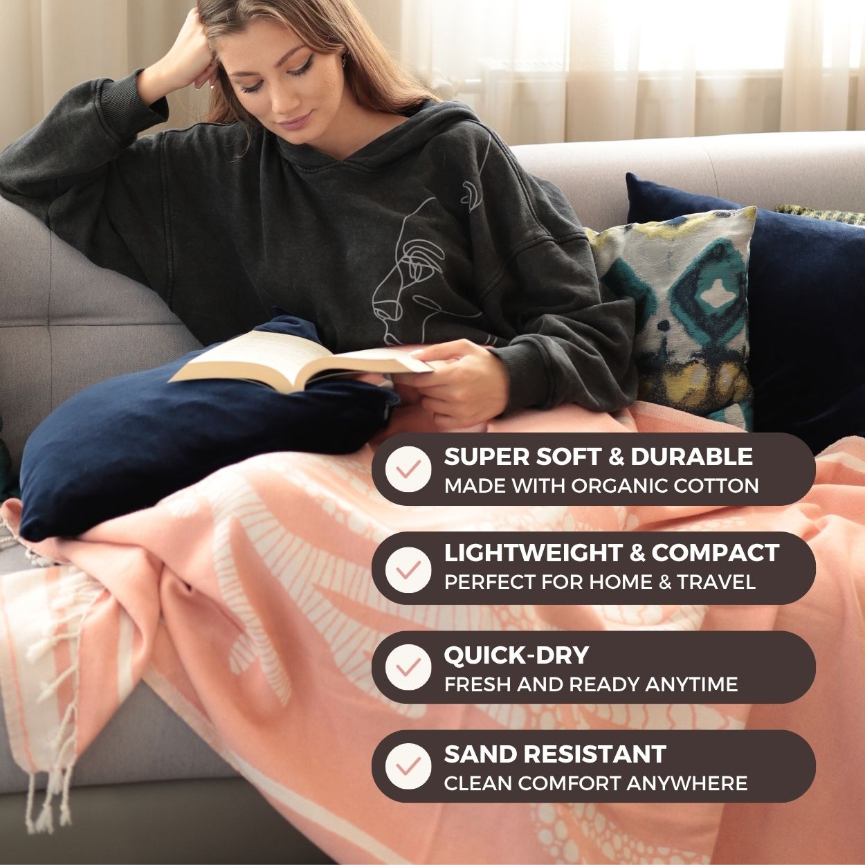 Woman sitting on a couch reading a book with a pink blanket, surrounded by text highlighting blanket features.